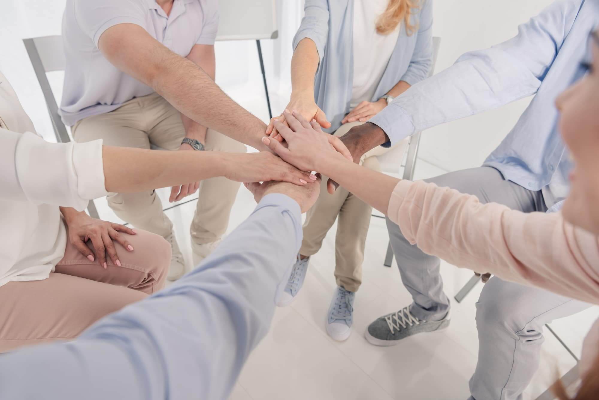 Cropped-shot-of-people-stacking-hands-during-group-therapy-1